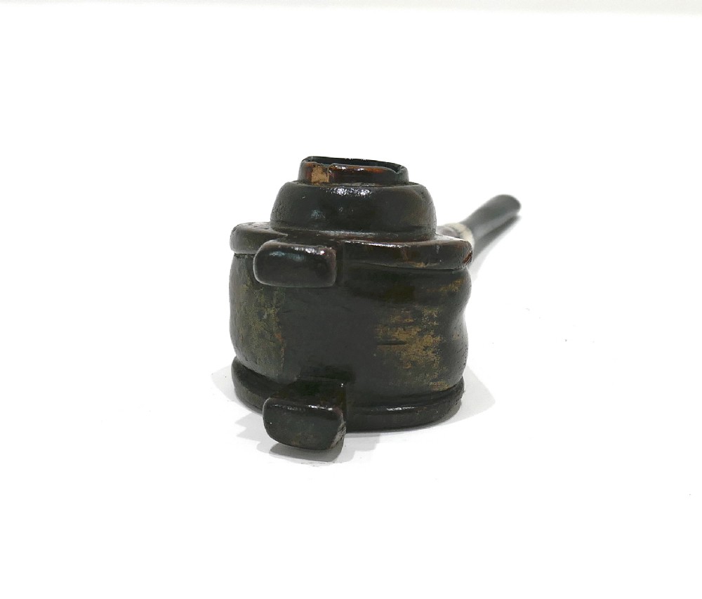 A nineteenth-century carved fruitwood tobacco pipe shaped like miniature fireplace bellows with an ebonised stem and metal ferrule band. View V