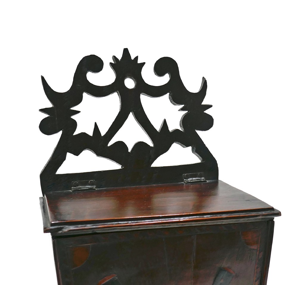 A wall-hanging Georgian mahogany cutlery box featuring a pierced cresting rail and inlaid crossed knife and fork pattern in boxwood and ebony. View II