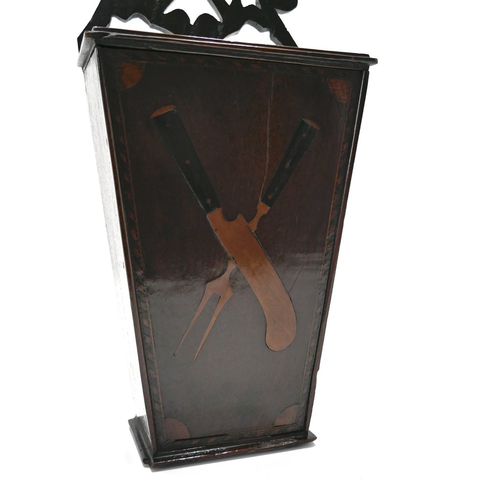A wall-hanging Georgian mahogany cutlery box featuring a pierced cresting rail and inlaid crossed knife and fork pattern in boxwood and ebony. View III