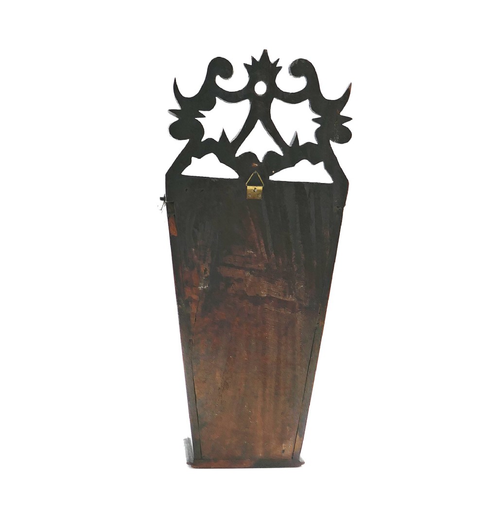 A wall-hanging Georgian mahogany cutlery box featuring a pierced cresting rail and inlaid crossed knife and fork pattern in boxwood and ebony. View V