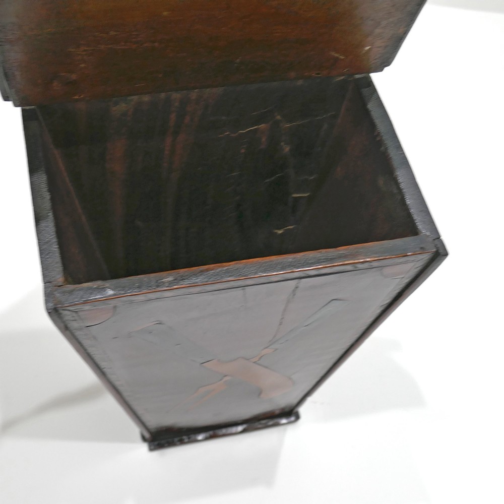 A wall-hanging Georgian mahogany cutlery box featuring a pierced cresting rail and inlaid crossed knife and fork pattern in boxwood and ebony. View VI