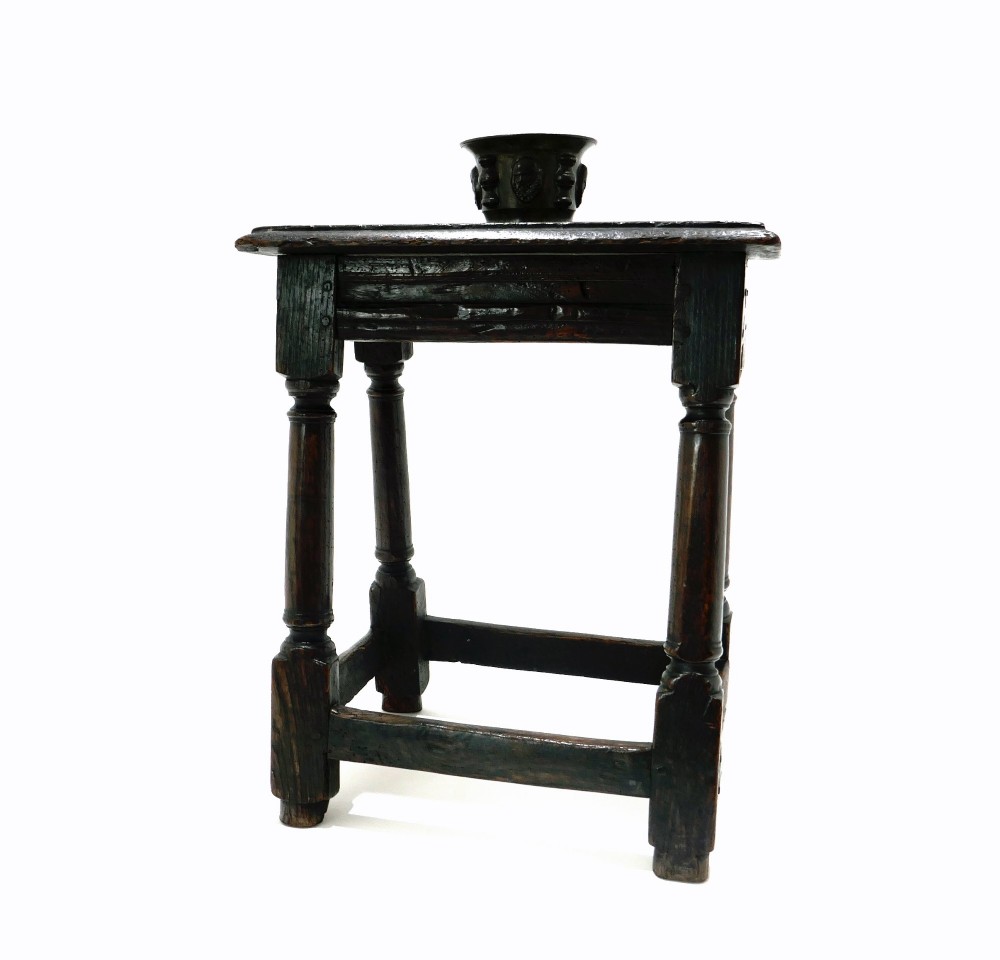 A 17th-century Commonwealth joined oak stool featuring turned legs, pegged mortise joints, lower stretchers, and a moulded rectangular seat. View V