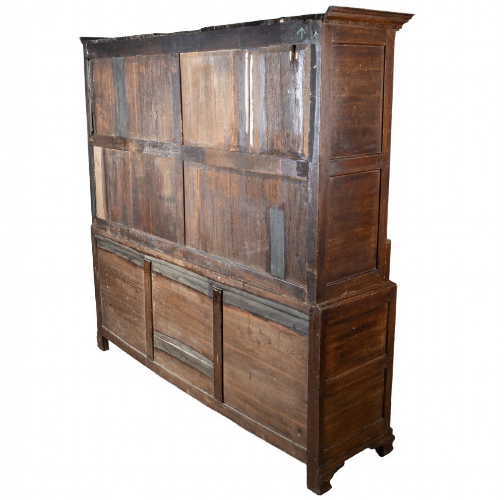 A large 18th-century Georgian dark oak press cupboard featuring an upper three-door cabinet with fielded panels over a lower base with nine brass-handled drawers. View III