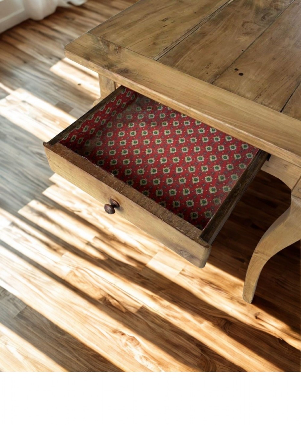 A late nineteenth-century French cherrywood dining table featuring curved cabriolet legs, a planked top, and an apron drawer. View VI