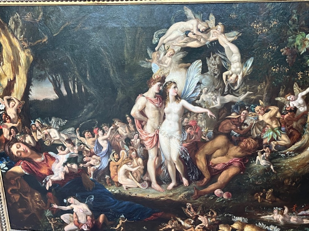 A 19th-century Victorian oil painting depicting a scene from Shakespeares A Midsummer Nights Dream featuring figures and winged fairies in a woodland setting.