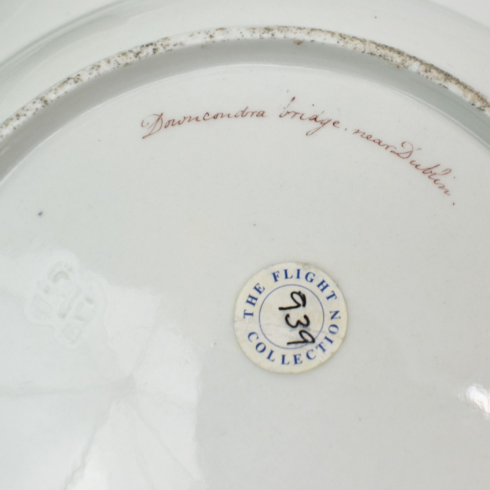 An antique circular porcelain plate featuring a scalloped gilded rim, cobalt blue border, hand-painted fruit and bird motifs, and a central landscape roundel. View VIII