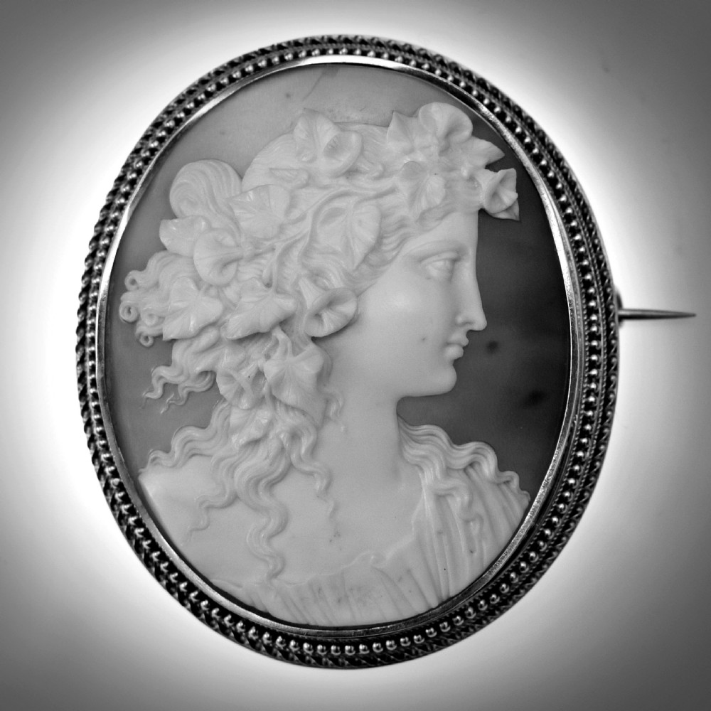 An oval Victorian cameo brooch featuring a white carved relief profile of Goddess Flora set within an 18ct gold frame with a twisted wire border. View IX