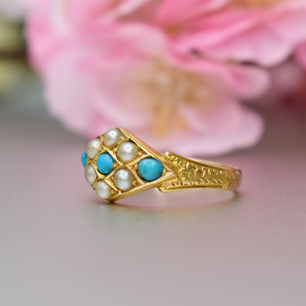 A late Victorian 15ct yellow gold ring featuring a diamond-shaped face set with turquoise cabochons and split pearls, flanked by engraved shoulders. View III