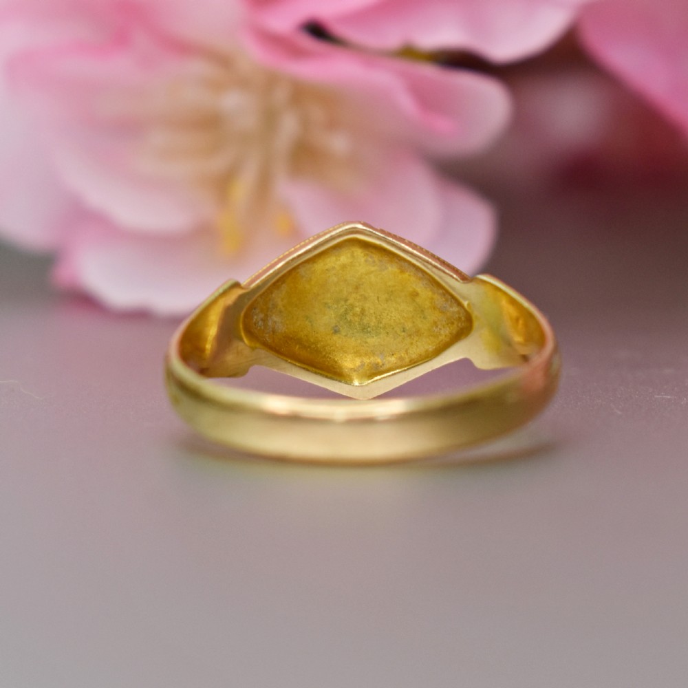 A late Victorian 15ct yellow gold ring featuring a diamond-shaped face set with turquoise cabochons and split pearls, flanked by engraved shoulders. View VIII