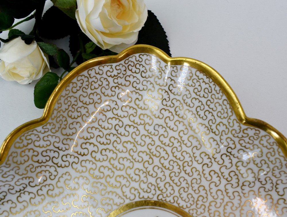 A square lobed white porcelain dish decorated with intricate gold scrollwork around a central hand-painted yellow butterfly medallion. View III