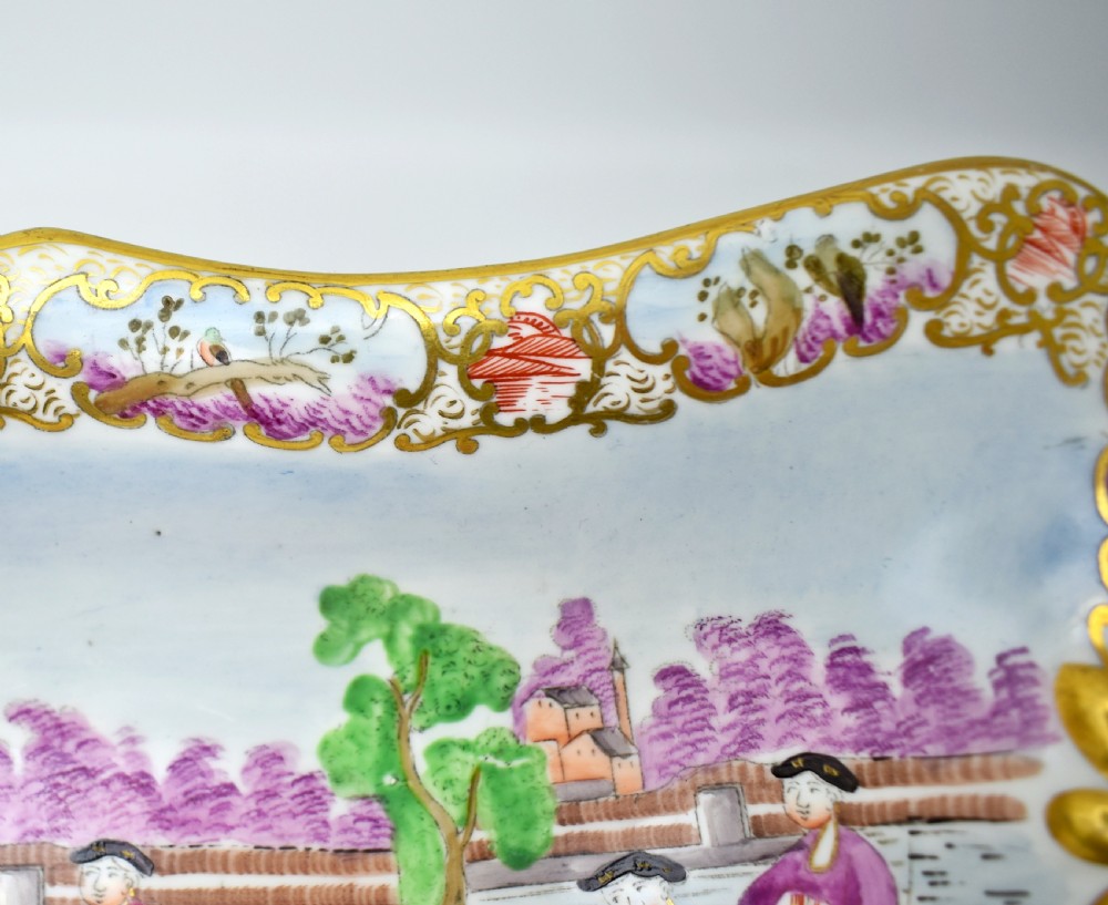 A Regency-era rectangular Swansea porcelain comport featuring gilded twin handles, a shaped border, and a polychrome hand-painted Mandarin Chinoiserie landscape scene. View VI