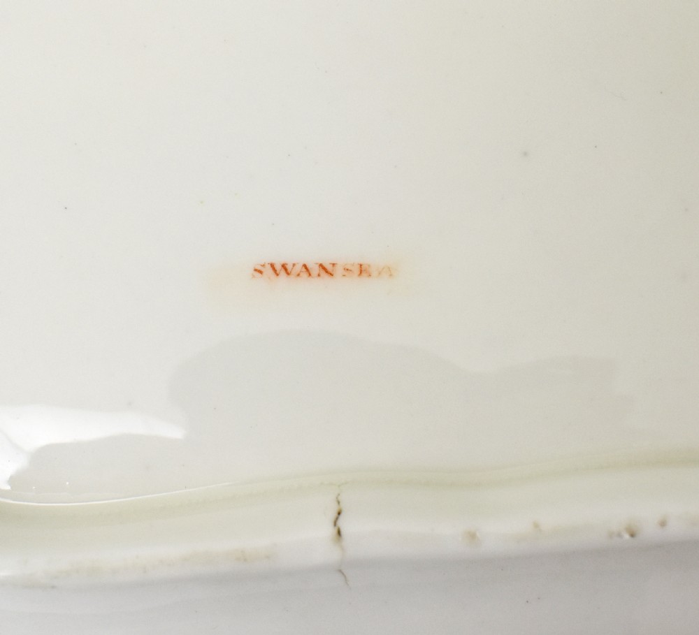 A Regency-era rectangular Swansea porcelain comport featuring gilded twin handles, a shaped border, and a polychrome hand-painted Mandarin Chinoiserie landscape scene. View XI