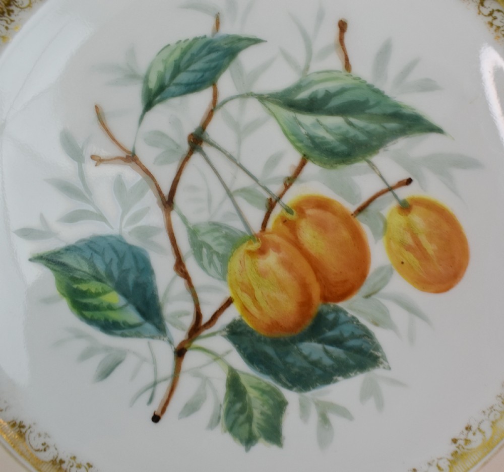 A set of four circular Russian porcelain plates decorated with hand-painted botanical fruit motifs, blush pink borders, and scalloped gilded rims. View VI