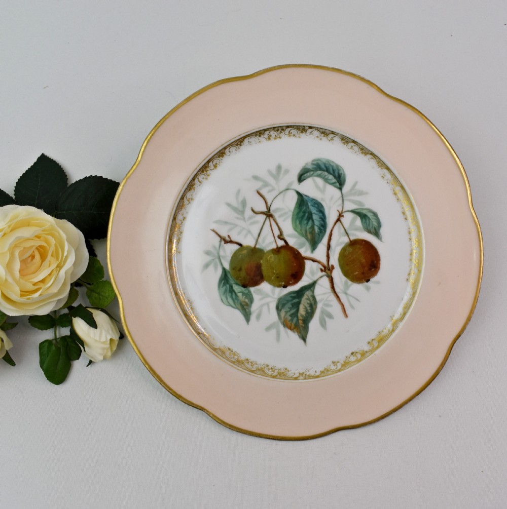 A set of four circular Russian porcelain plates decorated with hand-painted botanical fruit motifs, blush pink borders, and scalloped gilded rims. View XV