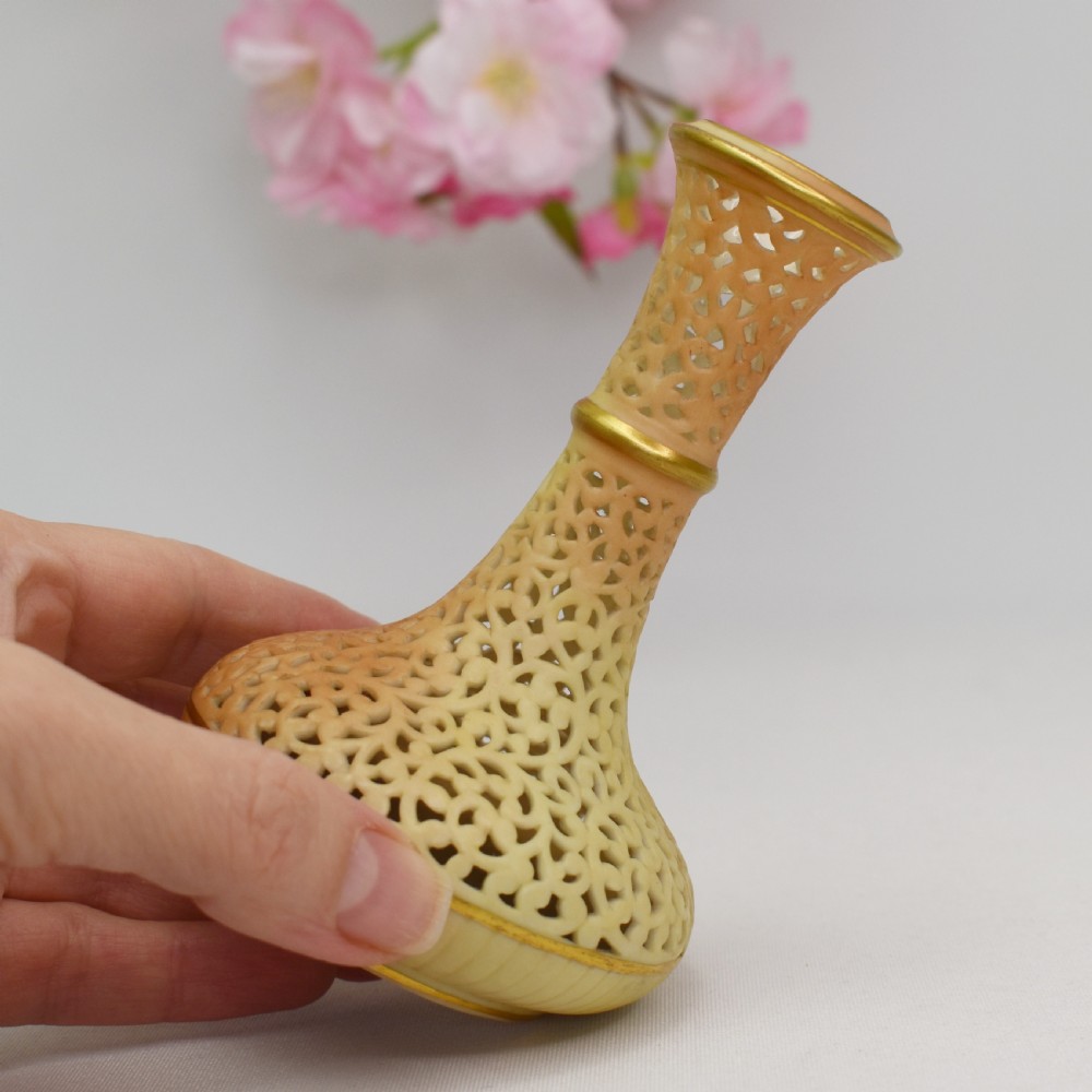 A Victorian Grainger Worcester reticulated porcelain bud vase with pierced openwork lattice decoration and gilded accents. View V