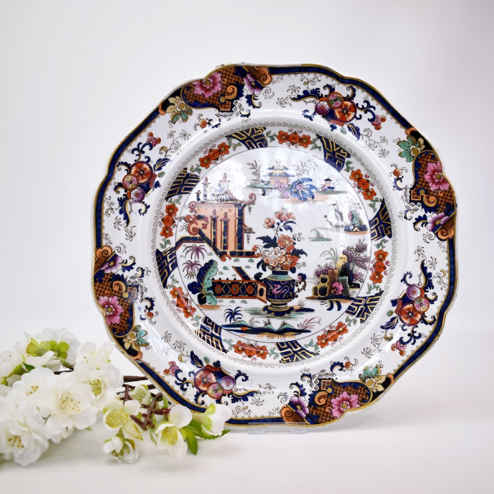 An octagonal Victorian stoneware plate by John Ridgway featuring an intricate Penang pattern with Chinoiserie pagodas, floral urns, cobalt blue borders, and gilded accents.