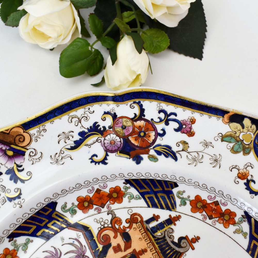 An octagonal Victorian stoneware plate by John Ridgway featuring an intricate Penang pattern with Chinoiserie pagodas, floral urns, cobalt blue borders, and gilded accents. View V