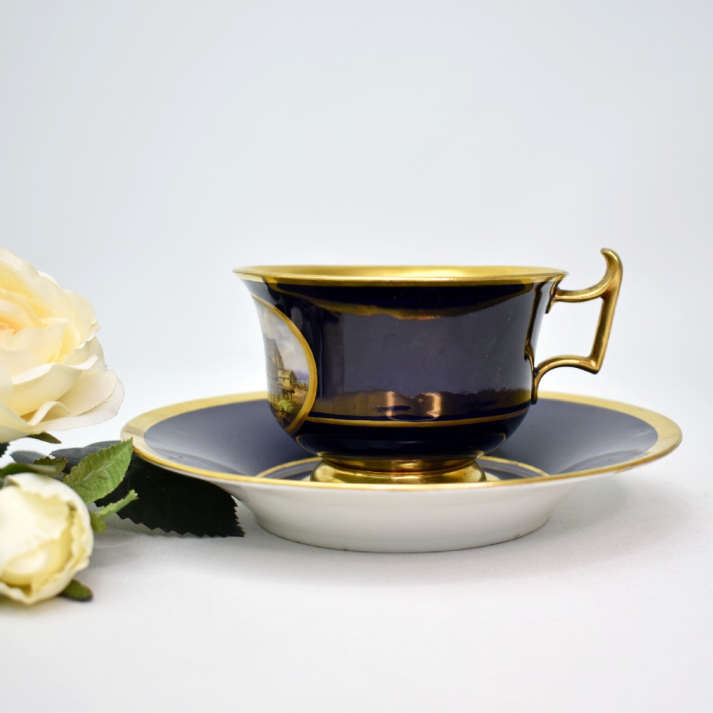 Fine 19th Century Meissen Cobalt and Burnished Gold Topographical Cup and Saucer, c.1830-40 View II