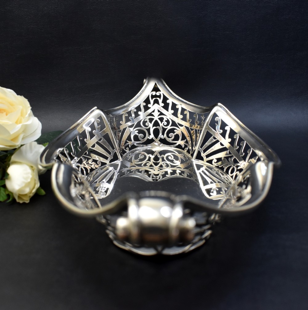 A sterling silver bread basket featuring pierced fretwork sides and swept scroll handles at both ends. View IV