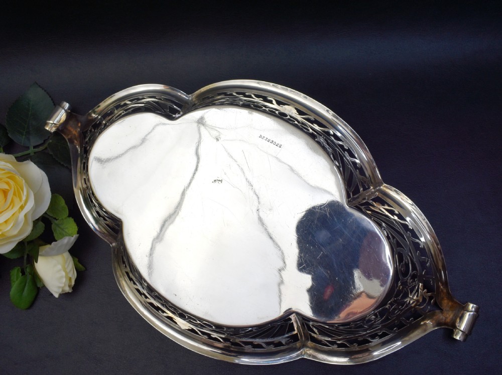 A sterling silver bread basket featuring pierced fretwork sides and swept scroll handles at both ends. View VI