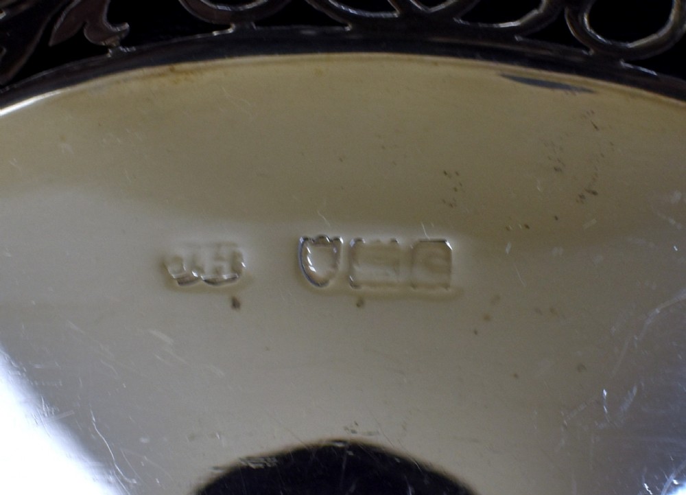 A sterling silver bread basket featuring pierced fretwork sides and swept scroll handles at both ends. View VIII