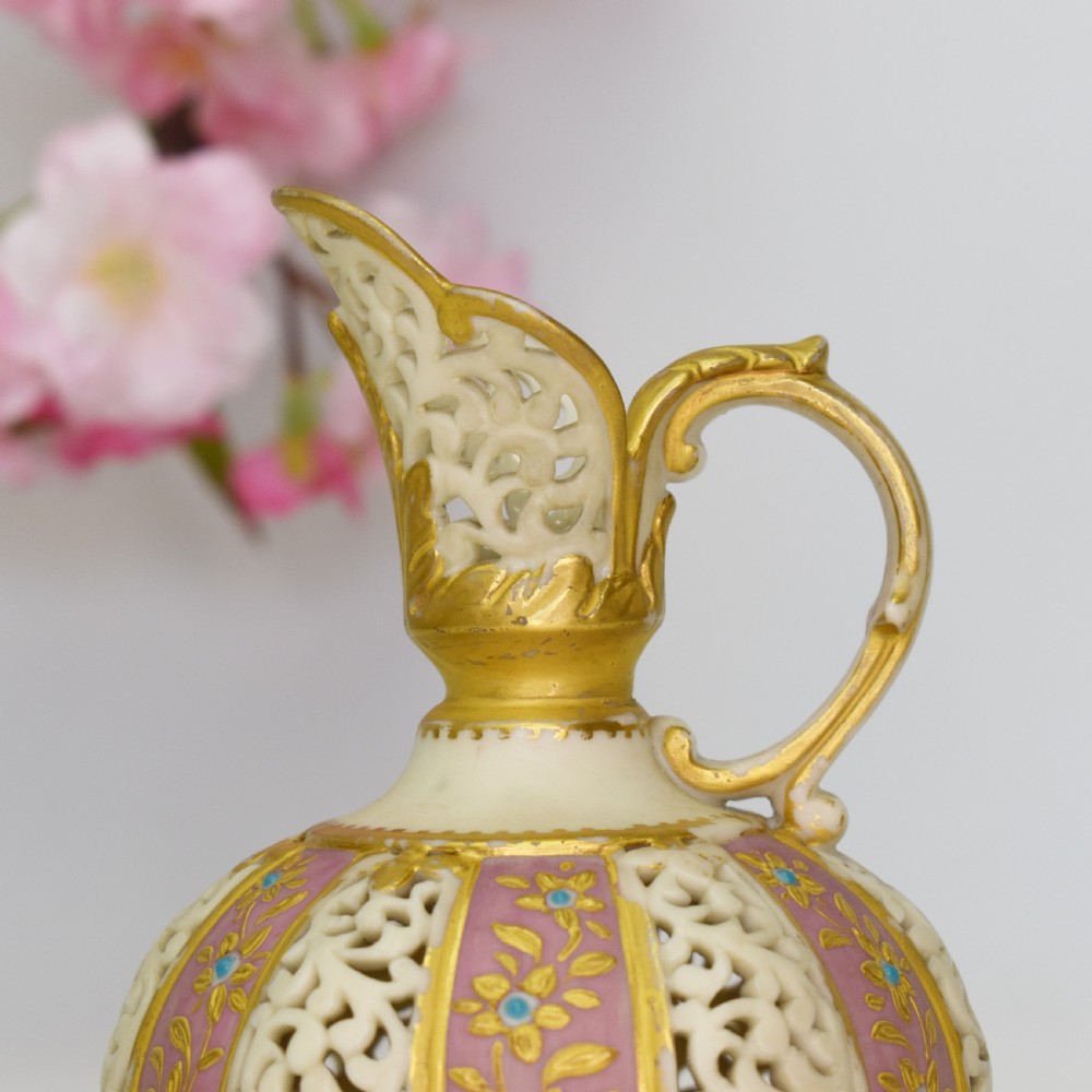 A late Victorian Grainger Worcester reticulated porcelain ewer featuring pink floral panels alternating with lattice pierced work and gilded accents. View V