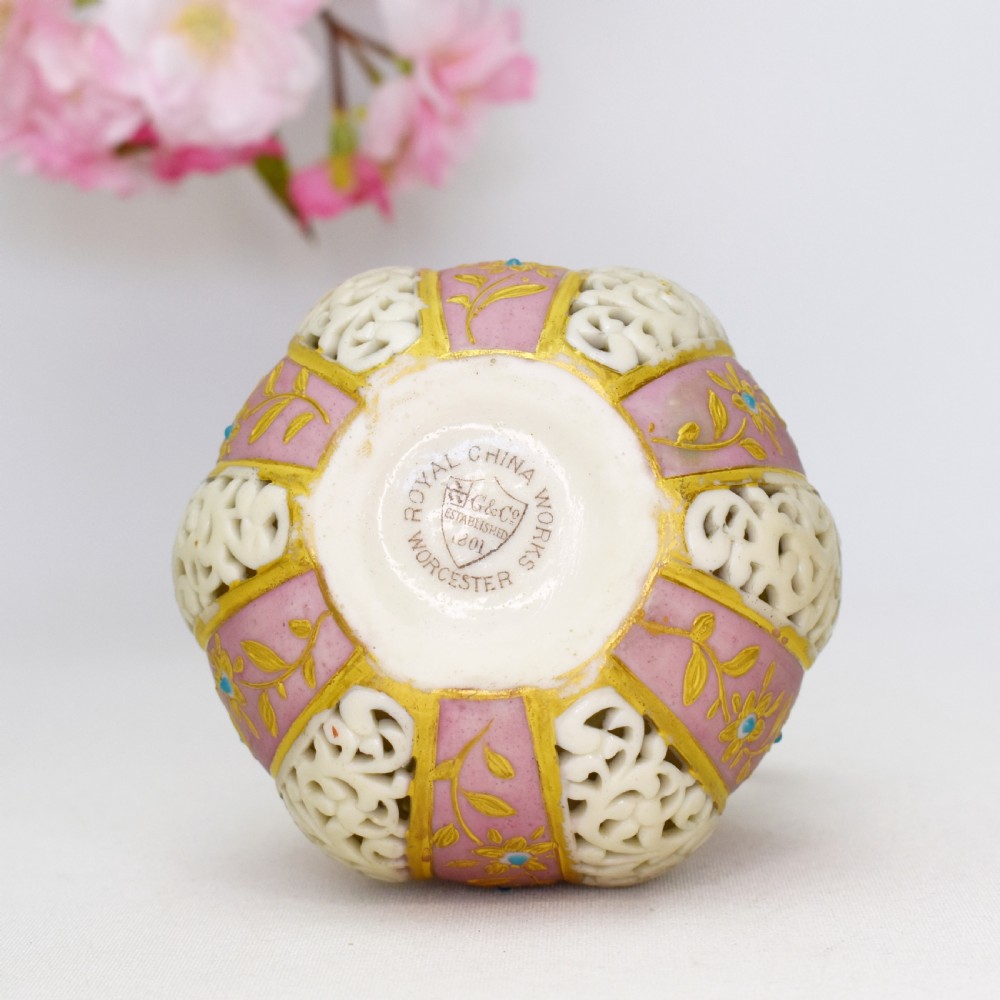 A late Victorian Grainger Worcester reticulated porcelain ewer featuring pink floral panels alternating with lattice pierced work and gilded accents. View IX