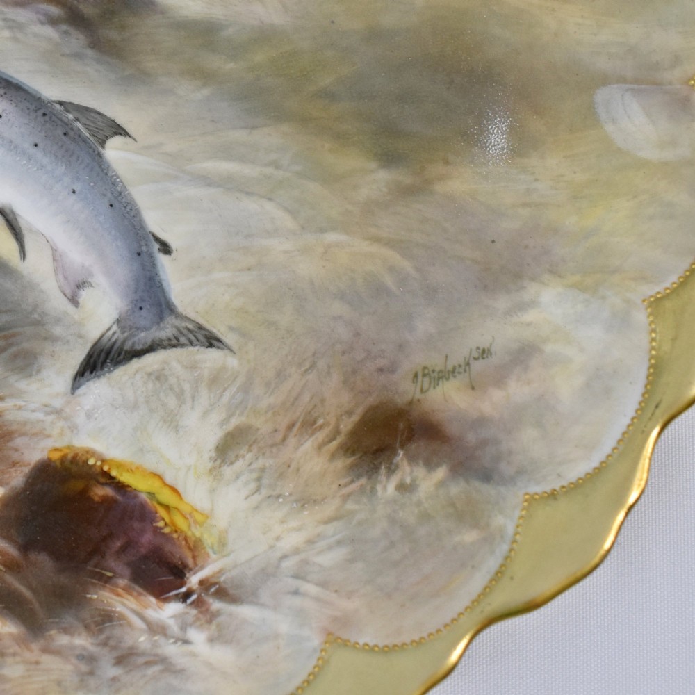A set of four circular porcelain cabinet plates with scalloped gold rims, each featuring a central hand-painted scene of fish swimming in natural river settings. View XI