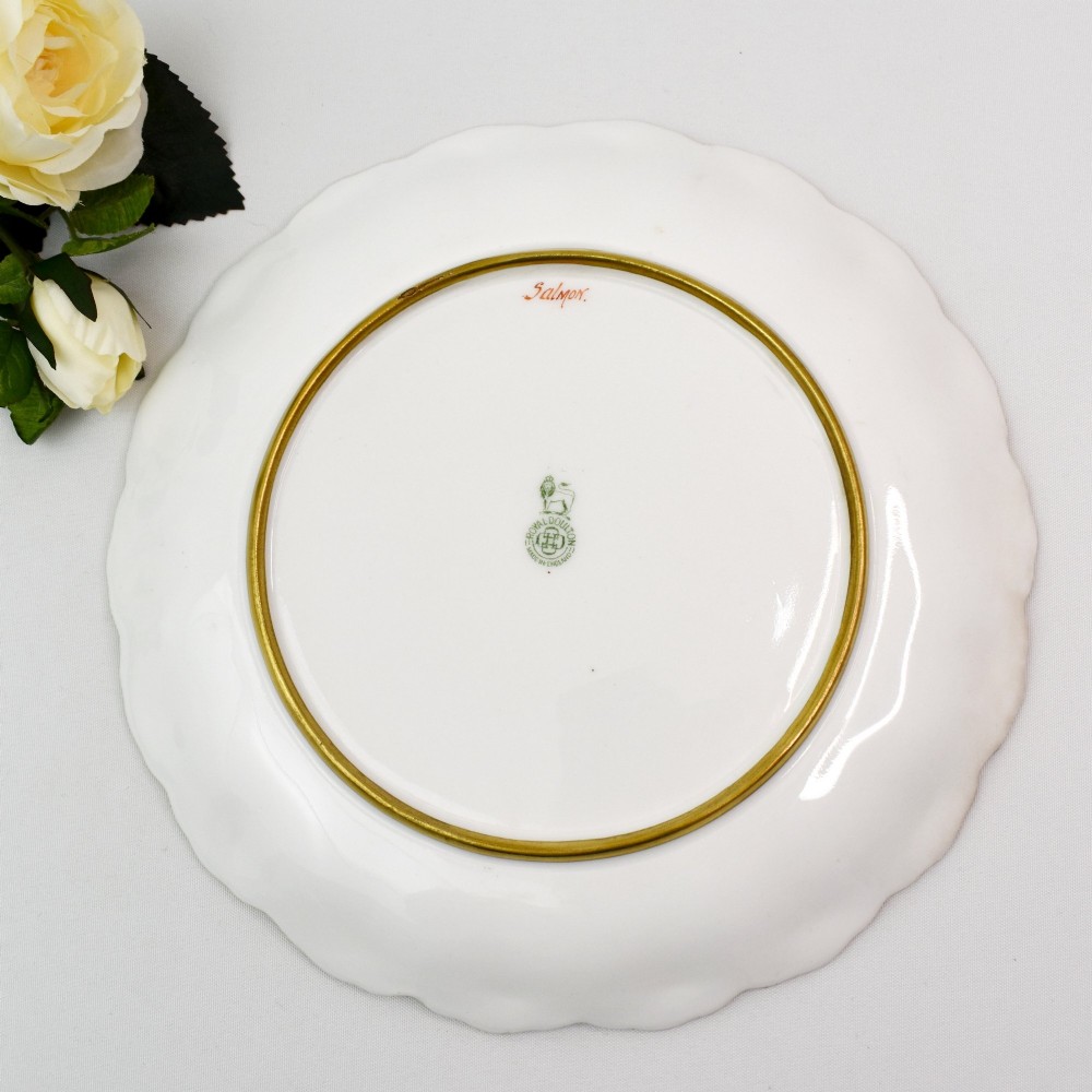 A set of four circular porcelain cabinet plates with scalloped gold rims, each featuring a central hand-painted scene of fish swimming in natural river settings. View XIII