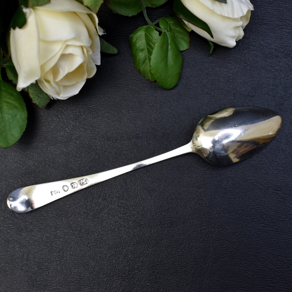 A set of six George III sterling silver teaspoons featuring bright-cut engraved stems and smooth oval bowls. View IV