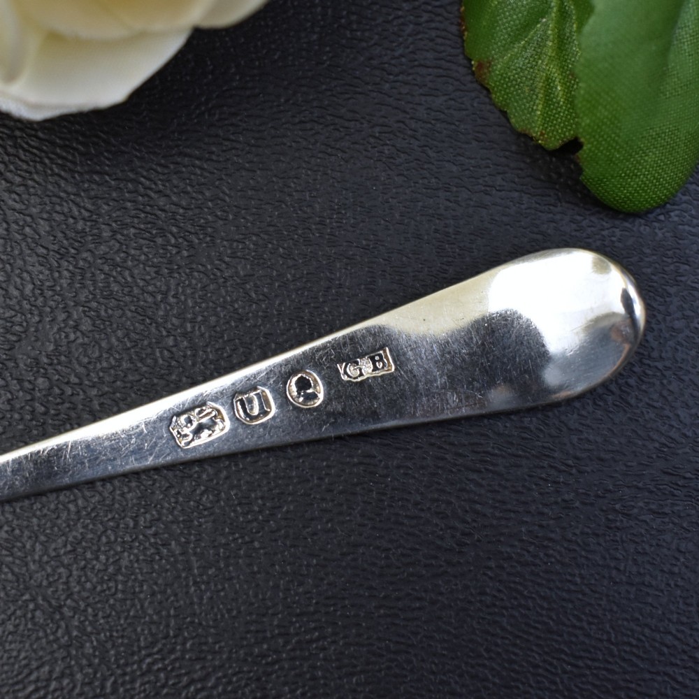 A set of six George III sterling silver teaspoons featuring bright-cut engraved stems and smooth oval bowls. View VI