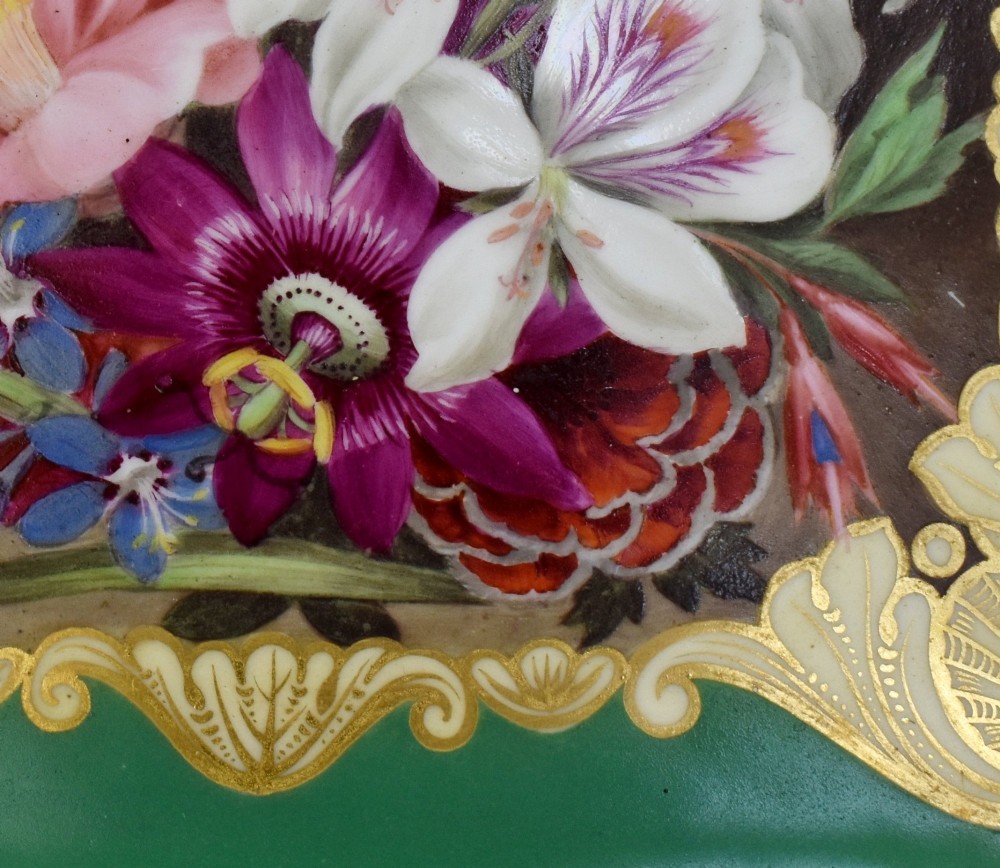 A rectangular green porcelain tray with elaborate gold scrollwork framing a hand-painted botanical bouquet in the centre. View V