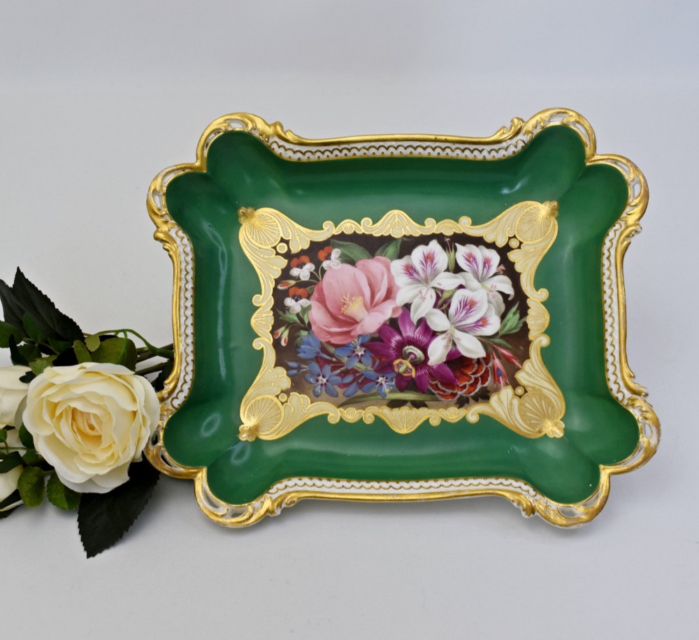 A rectangular green porcelain tray with elaborate gold scrollwork framing a hand-painted botanical bouquet in the centre. View VII