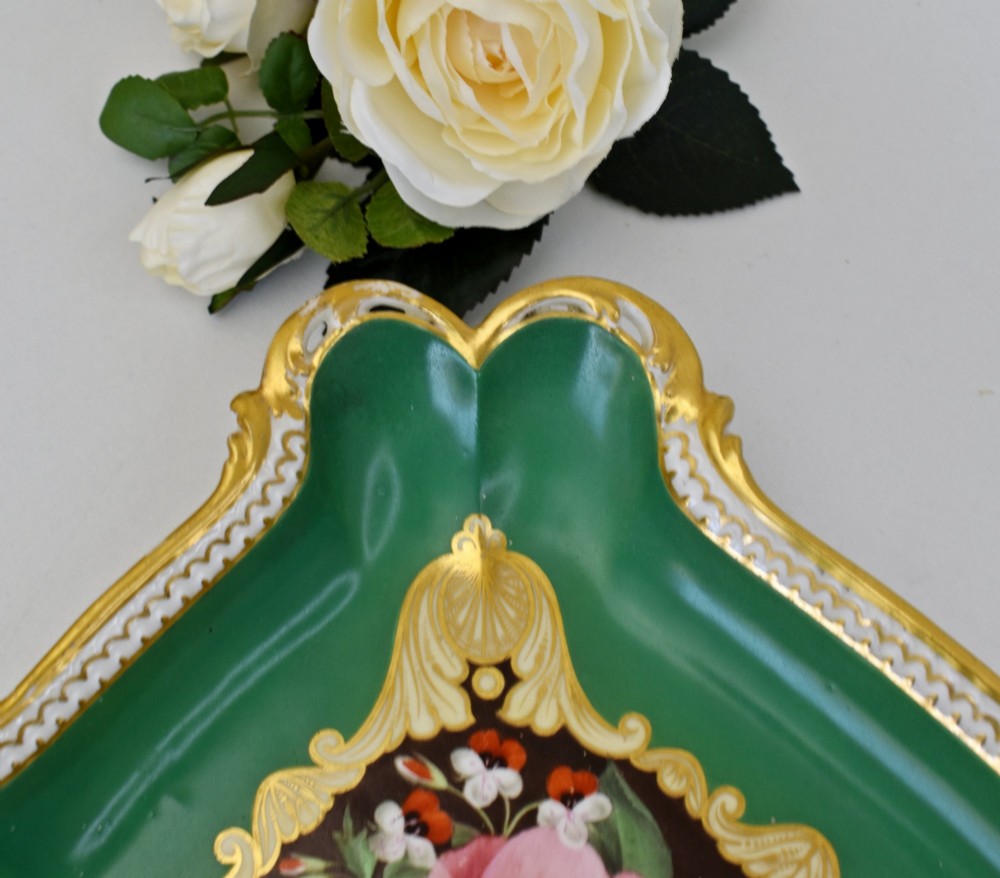 A rectangular green porcelain tray with elaborate gold scrollwork framing a hand-painted botanical bouquet in the centre. View VIII