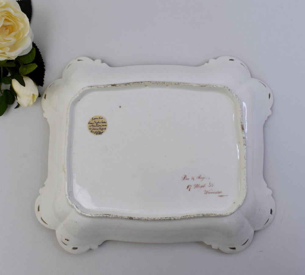 A rectangular green porcelain tray with elaborate gold scrollwork framing a hand-painted botanical bouquet in the centre. View IX