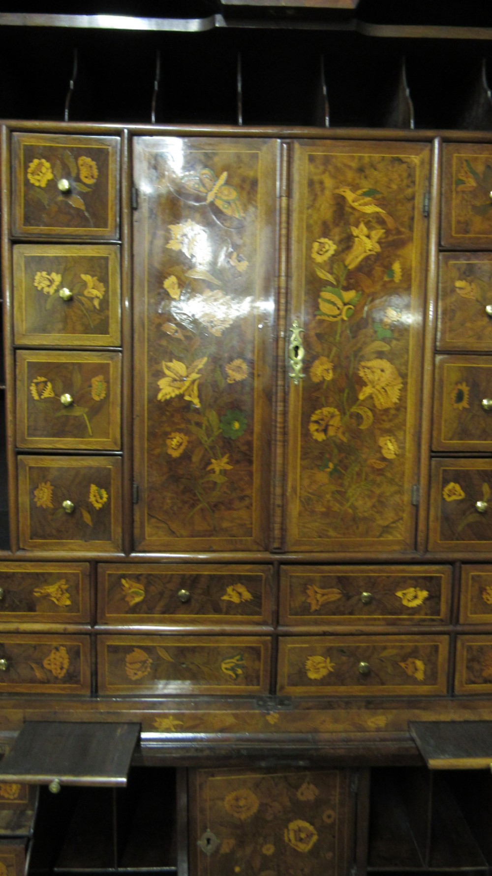 An 18th-century walnut bureau bookcase featuring intricate floral marquetry, a double-domed upper cabinet, a slant-front writing slope, and drawers raised on bun feet. View IV
