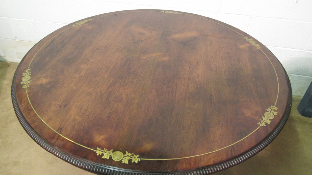 A circular Regency rosewood tilt-top loo table featuring brass marquetry inlay along the perimeter and a pedestal base. View III