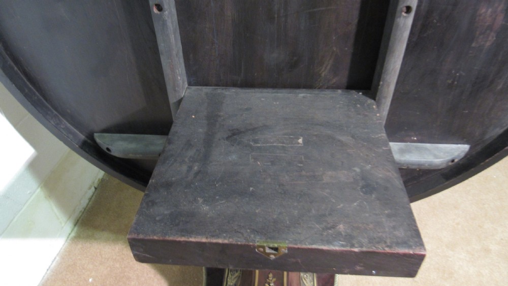 A circular Regency rosewood tilt-top loo table featuring brass marquetry inlay along the perimeter and a pedestal base. View IX