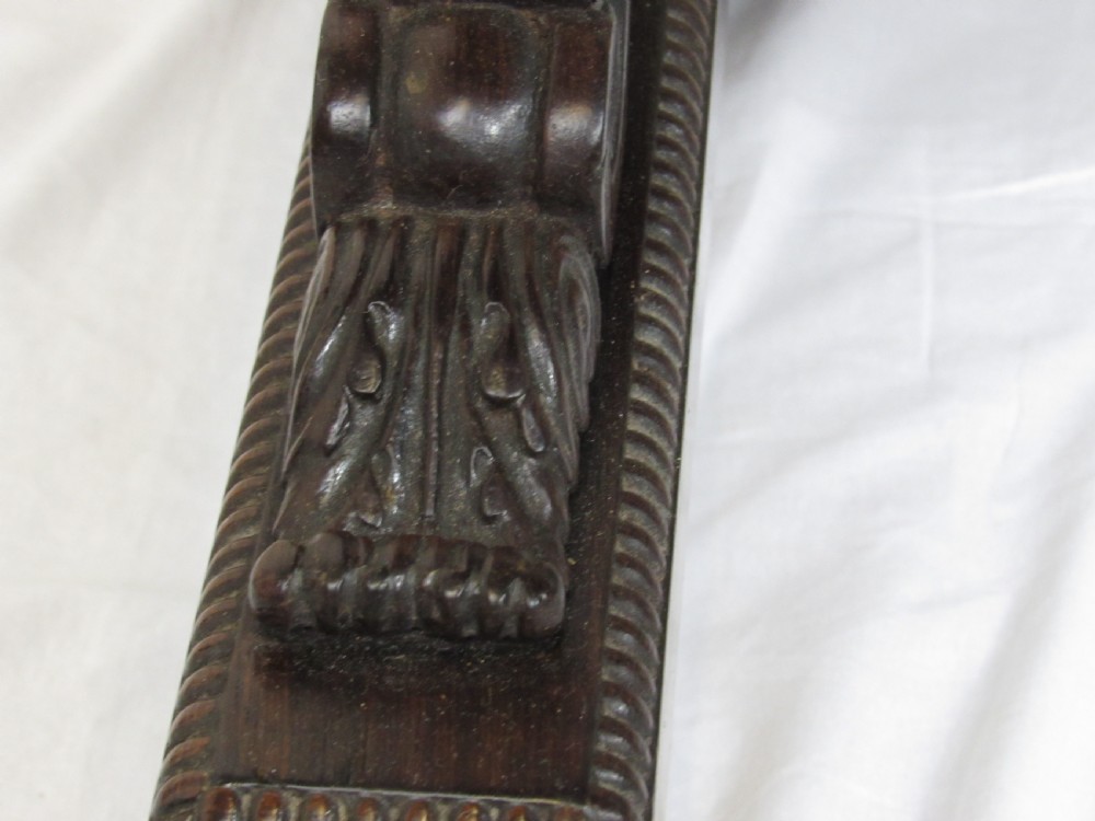 A 19th-century dark rosewood sofa table with two frieze drawers, drop-leaf side flaps, a turned central stretcher, and carved lion paw feet. View V