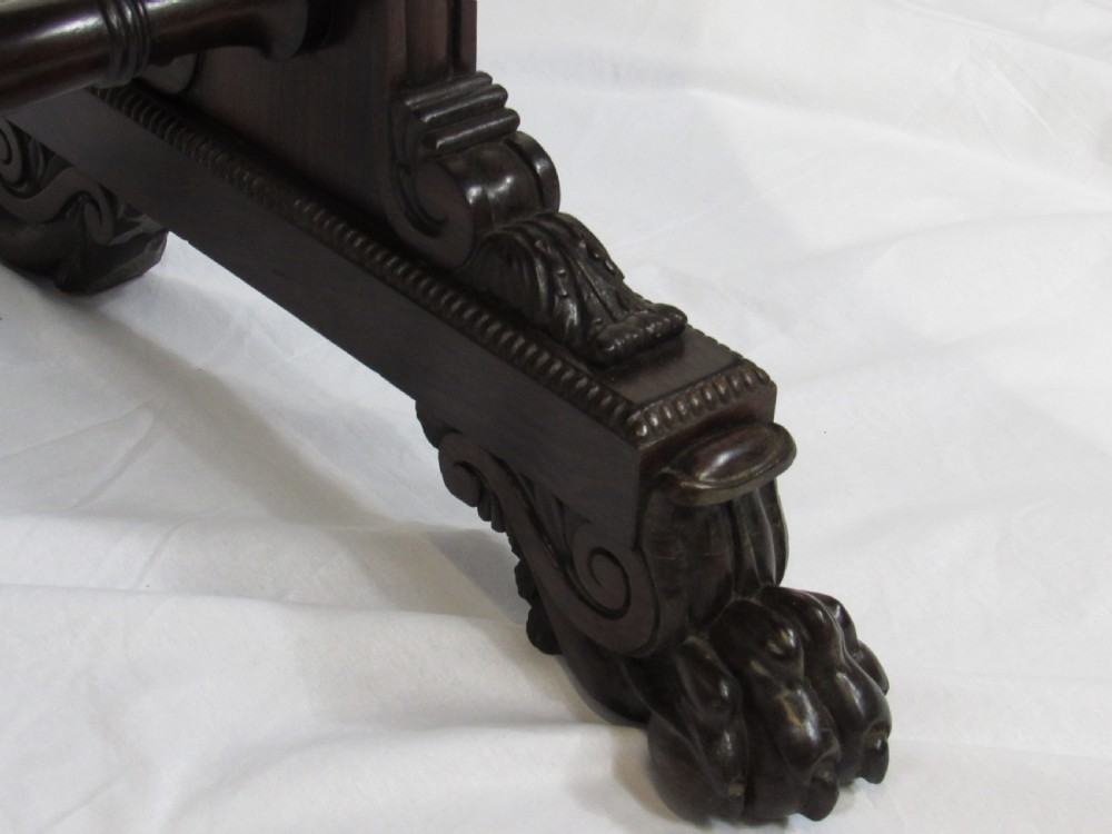 A 19th-century dark rosewood sofa table with two frieze drawers, drop-leaf side flaps, a turned central stretcher, and carved lion paw feet. View VII