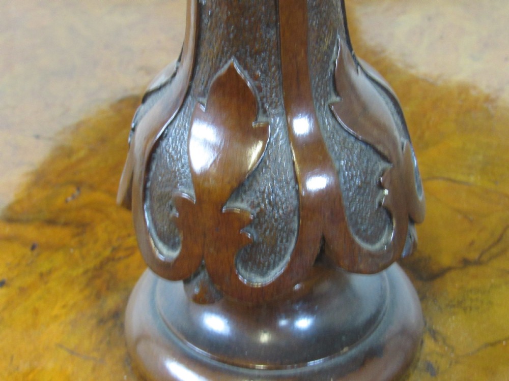 A Victorian burr walnut three-tier oval what-not etagere with turned columns, top finials, and carved feet on castors. View V
