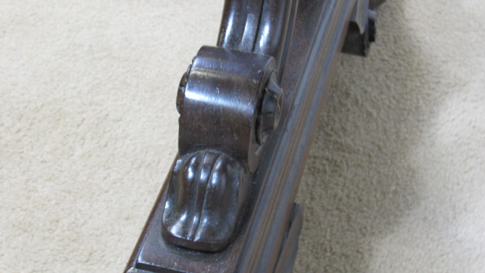 A dark rosewood library table featuring a polished rectangular top, frieze drawer, carved scroll trestle ends, a turned stretcher, and carved feet. View IX