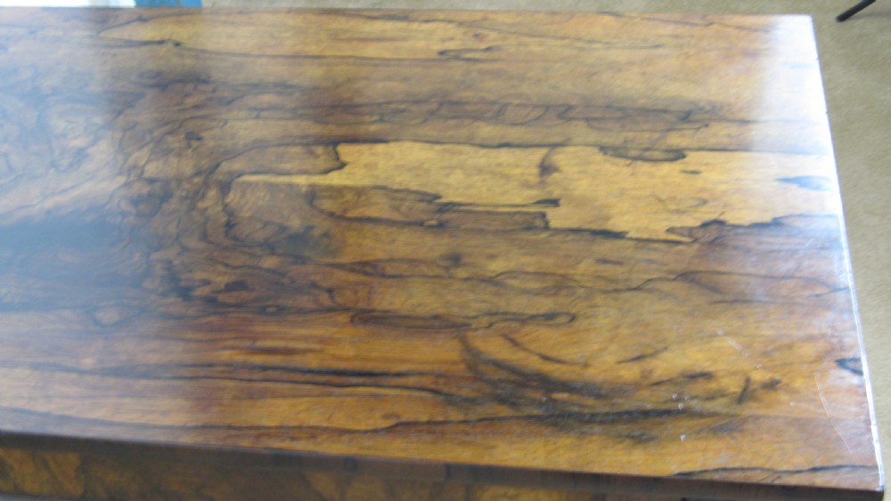 A dark rosewood library table featuring a polished rectangular top, frieze drawer, carved scroll trestle ends, a turned stretcher, and carved feet. View XII