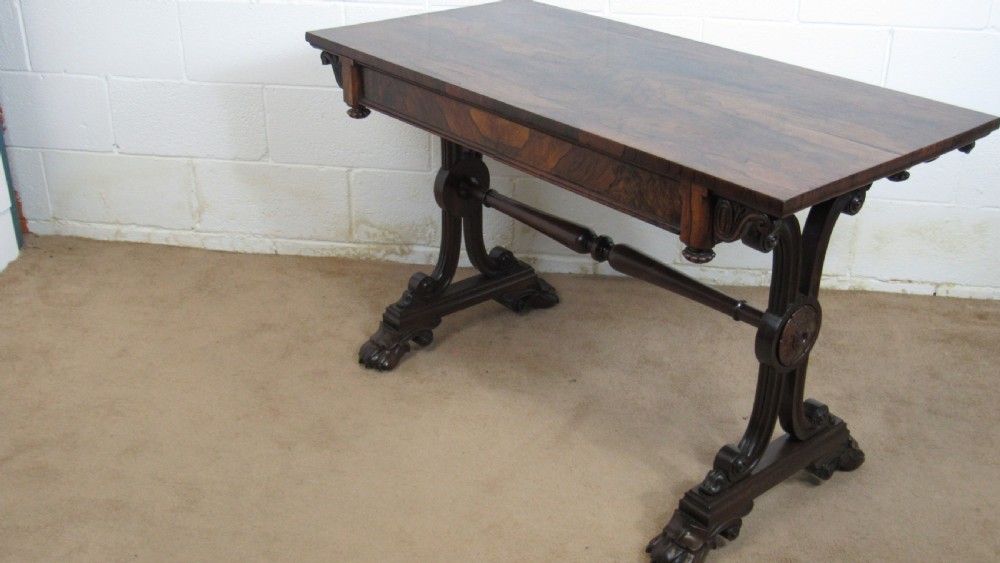 A dark rosewood library table featuring a polished rectangular top, frieze drawer, carved scroll trestle ends, a turned stretcher, and carved feet. View XVI