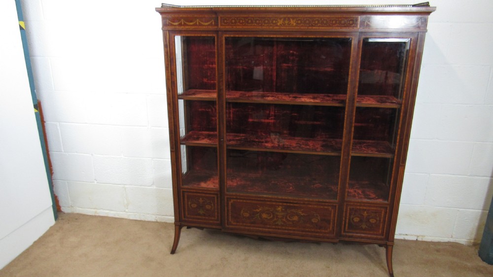 An Edwardian fiddleback mahogany display cabinet featuring glazed doors, detailed floral marquetry inlay on the lower panels, and square tapered legs. View III