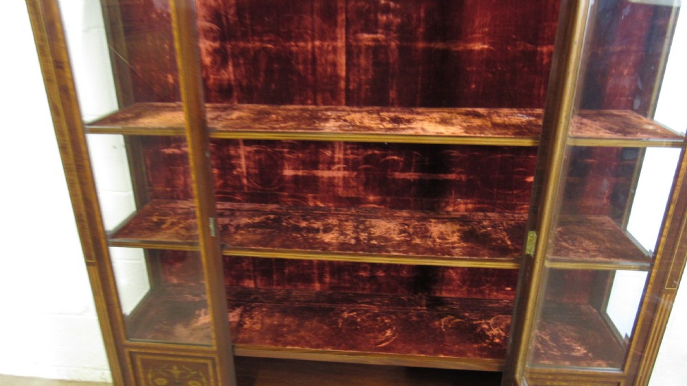 An Edwardian fiddleback mahogany display cabinet featuring glazed doors, detailed floral marquetry inlay on the lower panels, and square tapered legs. View XVIII