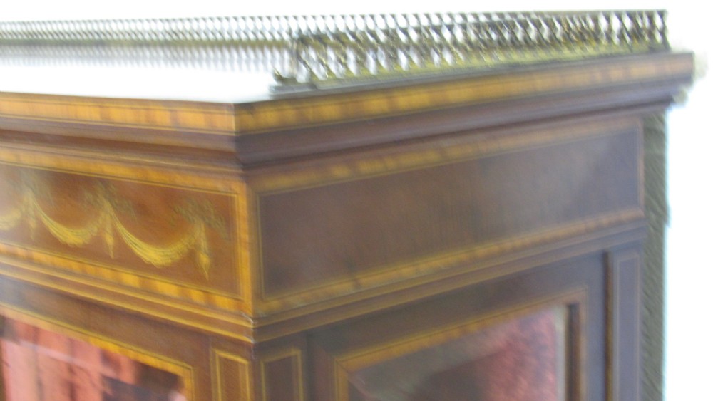 An Edwardian fiddleback mahogany display cabinet featuring glazed doors, detailed floral marquetry inlay on the lower panels, and square tapered legs. View XX