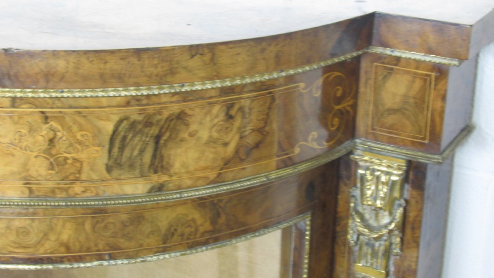 A Victorian burr walnut credenza featuring a central inlaid panel door flanked by two curved glazed display cupboards with gilt brass mounts. View V