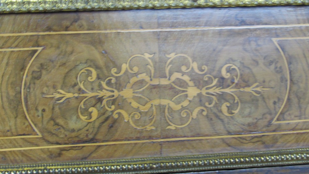 A Victorian burr walnut credenza featuring a central inlaid panel door flanked by two curved glazed display cupboards with gilt brass mounts. View IX