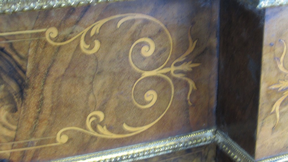 A Victorian burr walnut credenza featuring a central inlaid panel door flanked by two curved glazed display cupboards with gilt brass mounts. View XVIII